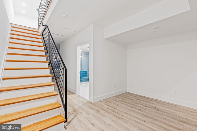 stairway featuring hardwood / wood-style floors