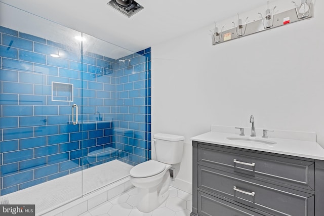 bathroom featuring vanity, tile patterned floors, toilet, and an enclosed shower