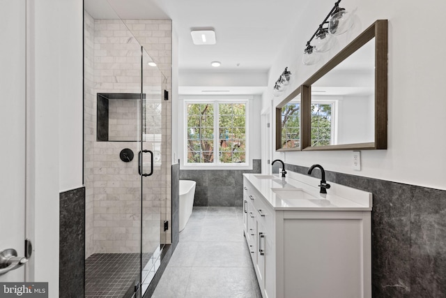 bathroom with vanity, tile walls, independent shower and bath, and tile patterned flooring