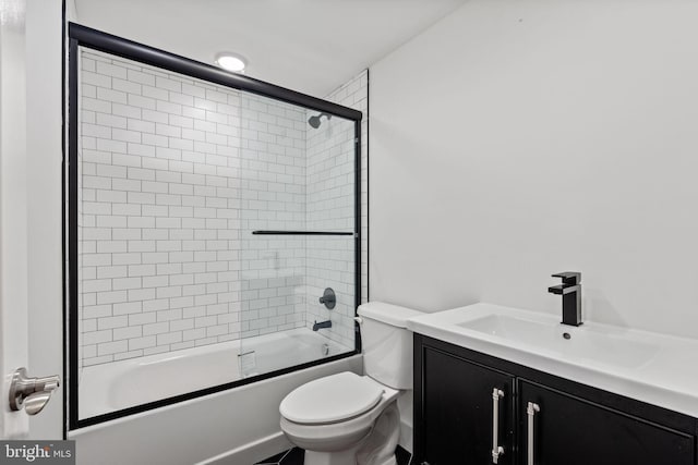 full bathroom with vanity, shower / bath combination with glass door, and toilet