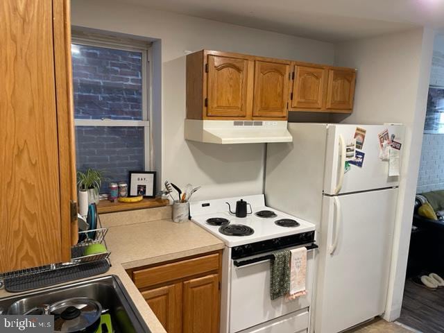 kitchen featuring sink and white appliances