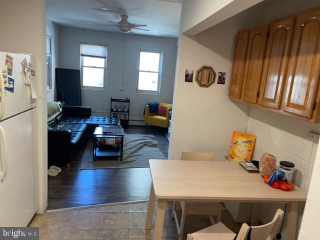 dining room featuring wood-type flooring and ceiling fan