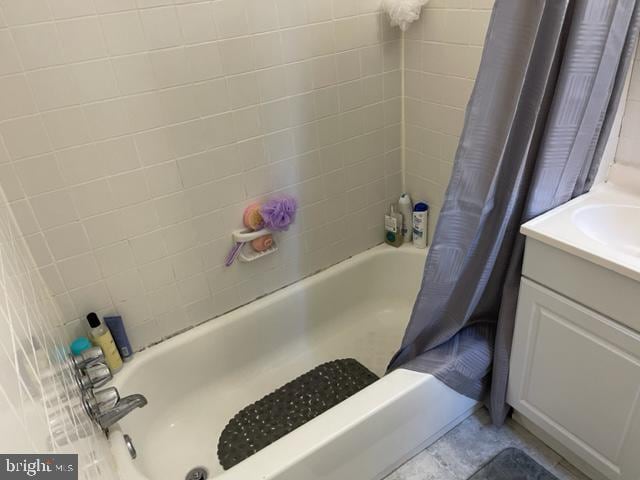 bathroom with tile flooring, vanity, and shower / bath combo with shower curtain