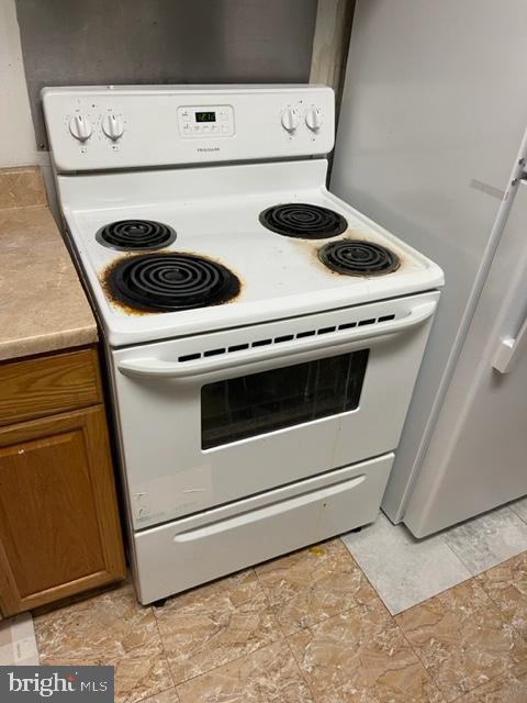 kitchen featuring white appliances and light tile floors