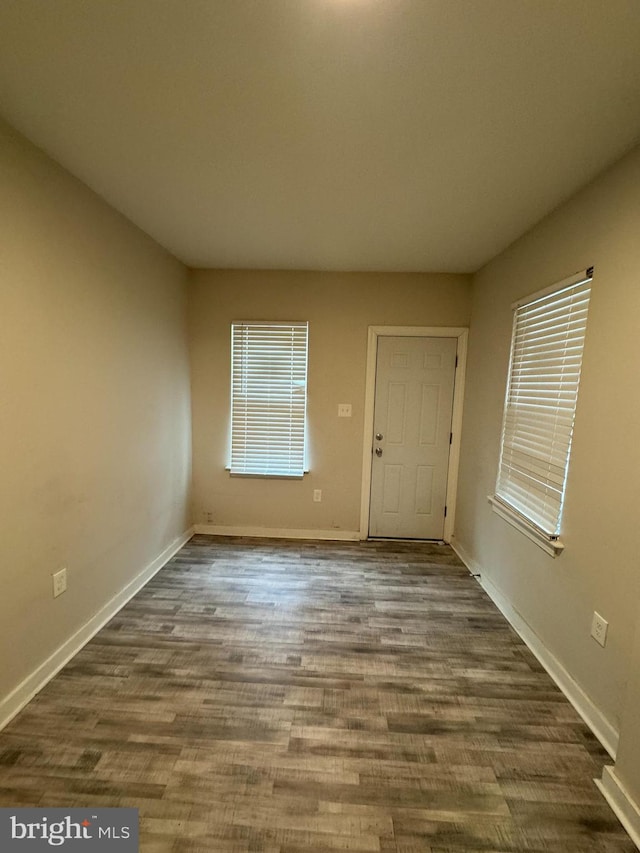 spare room with dark hardwood / wood-style flooring