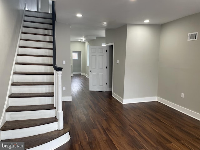 staircase with dark hardwood / wood-style floors