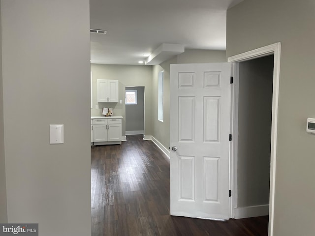 hallway featuring dark hardwood / wood-style flooring