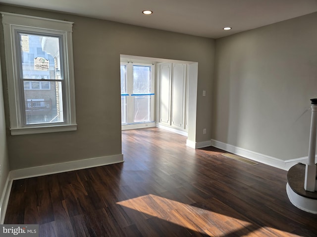 spare room featuring dark hardwood / wood-style floors