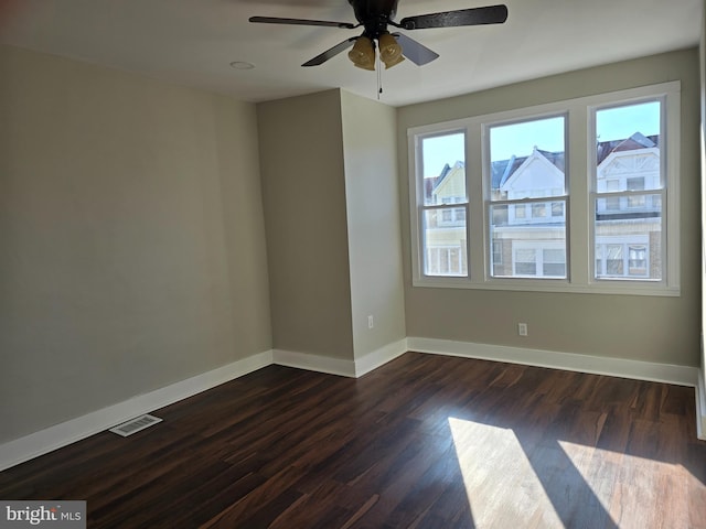 unfurnished room with dark hardwood / wood-style flooring and ceiling fan