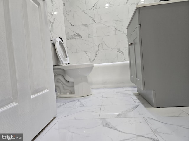 bathroom featuring toilet and tile flooring