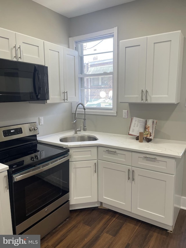 kitchen featuring sink, stainless steel electric stove, dark hardwood / wood-style floors, and white cabinetry