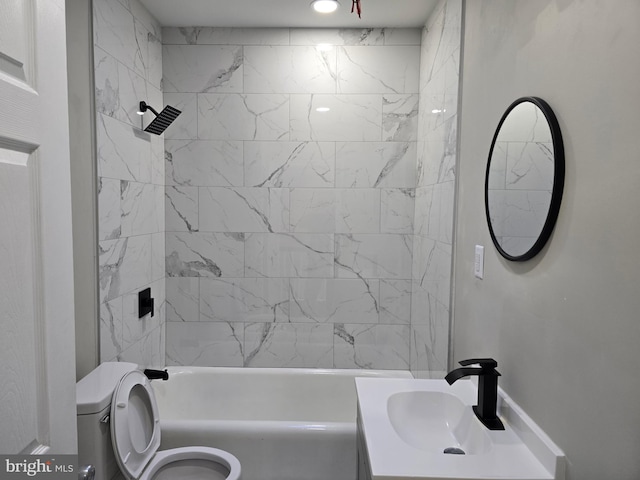 full bathroom with oversized vanity, toilet, and tiled shower / bath