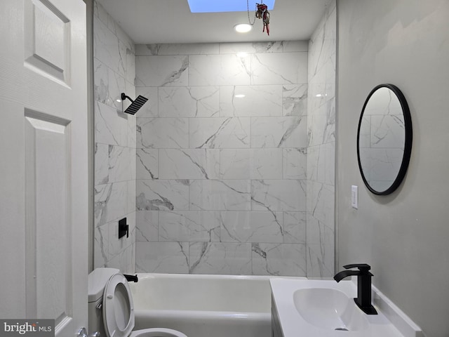 full bathroom featuring toilet, vanity, and tiled shower / bath