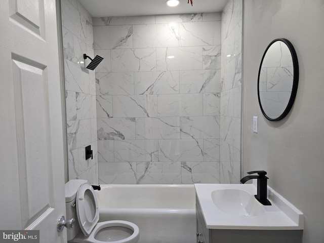 full bathroom featuring tiled shower / bath combo, toilet, and vanity with extensive cabinet space