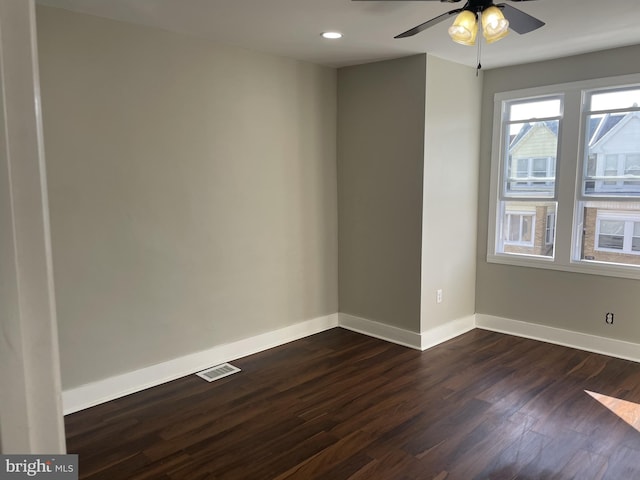 empty room featuring ceiling fan and dark wood-type flooring