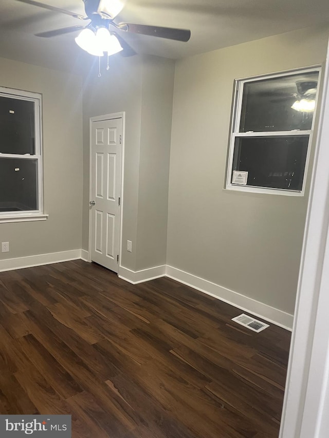 spare room featuring ceiling fan and dark hardwood / wood-style flooring