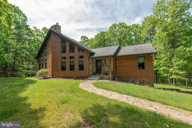 log cabin with a front yard