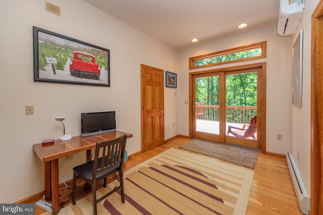 office with a baseboard radiator, a wall mounted AC, and light hardwood / wood-style floors