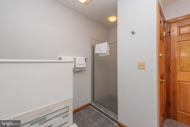 bathroom featuring a shower with door and tile patterned floors