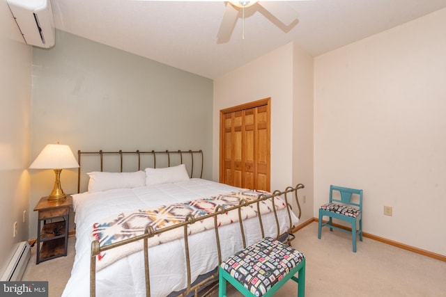 bedroom featuring a wall unit AC, ceiling fan, a closet, baseboard heating, and light colored carpet