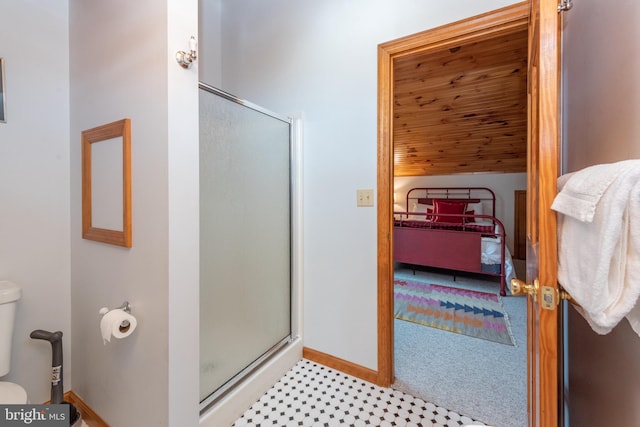 bathroom with toilet and a shower with shower door