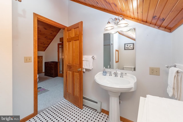 bathroom with vaulted ceiling, a baseboard heating unit, and wood ceiling