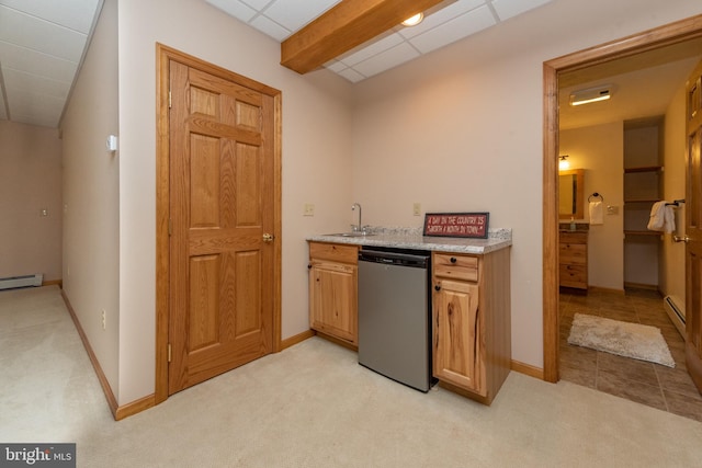 kitchen featuring light carpet, dishwasher, and a paneled ceiling