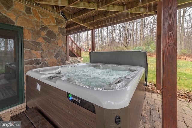 view of patio featuring a hot tub and a grill