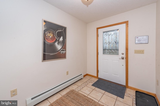 foyer entrance with a textured ceiling, a baseboard radiator, and light tile patterned floors