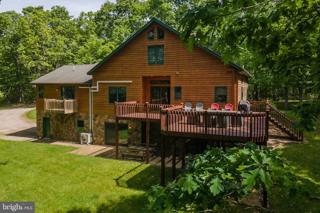 back of property featuring ac unit, a yard, and a deck