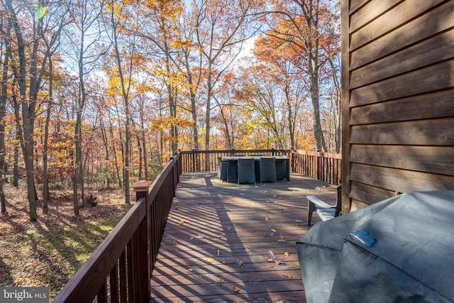 wooden terrace with a grill