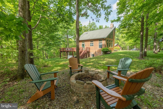 view of yard with a deck and a fire pit