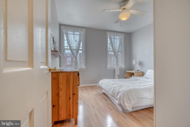 bedroom featuring light hardwood / wood-style floors and ceiling fan