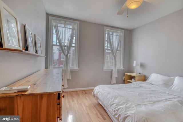 bedroom featuring light hardwood / wood-style floors and ceiling fan