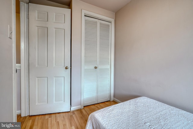 bedroom with a closet and light hardwood / wood-style floors