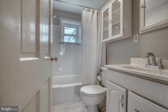 full bathroom featuring large vanity, shower / bathtub combination with curtain, and toilet