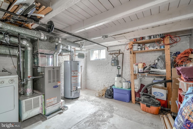 basement with water heater and washer / dryer