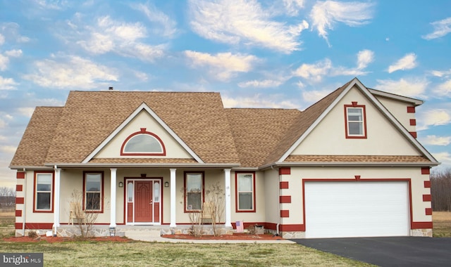 view of front of property with a front lawn, a porch, and a garage