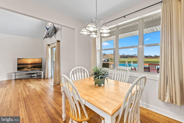 dining room with an inviting chandelier and light hardwood / wood-style flooring