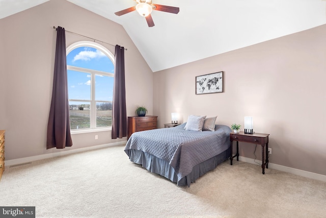 carpeted bedroom with ceiling fan and vaulted ceiling