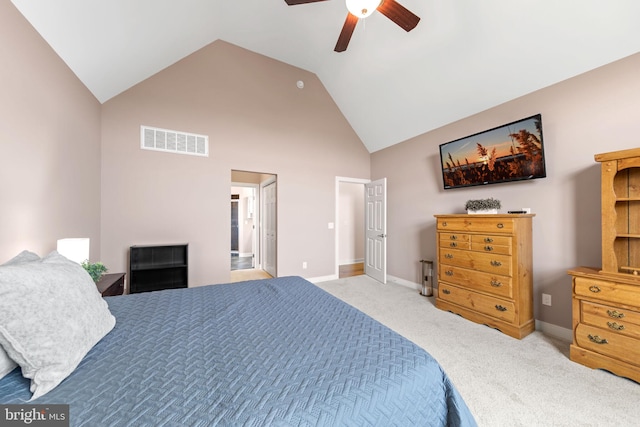 carpeted bedroom with ceiling fan and high vaulted ceiling