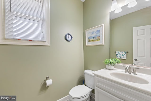 bathroom featuring toilet and large vanity