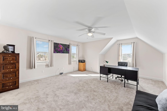 home office featuring lofted ceiling, light carpet, and ceiling fan