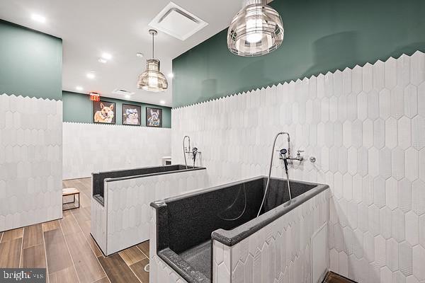 interior space with a washtub and wood-type flooring