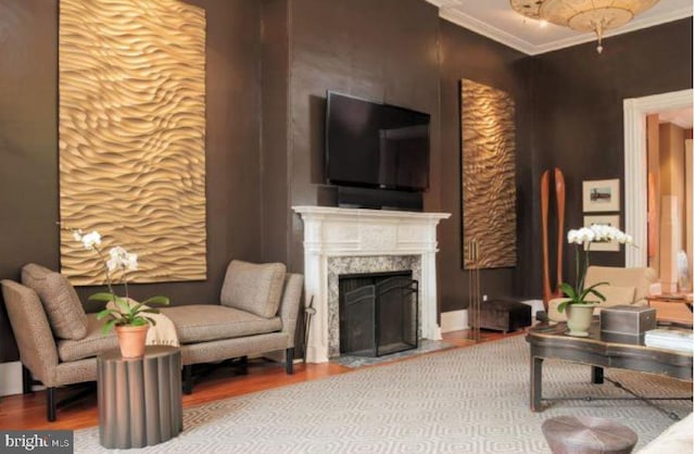 living room featuring a premium fireplace, crown molding, and hardwood / wood-style floors