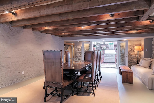 dining space with beam ceiling