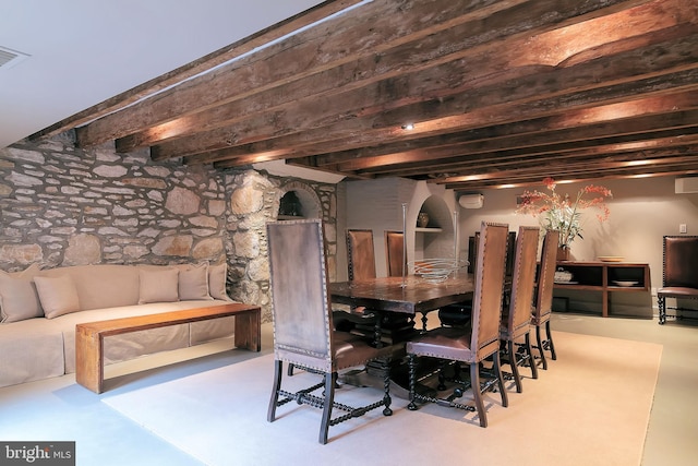 dining area with beamed ceiling