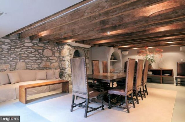 dining space with beam ceiling