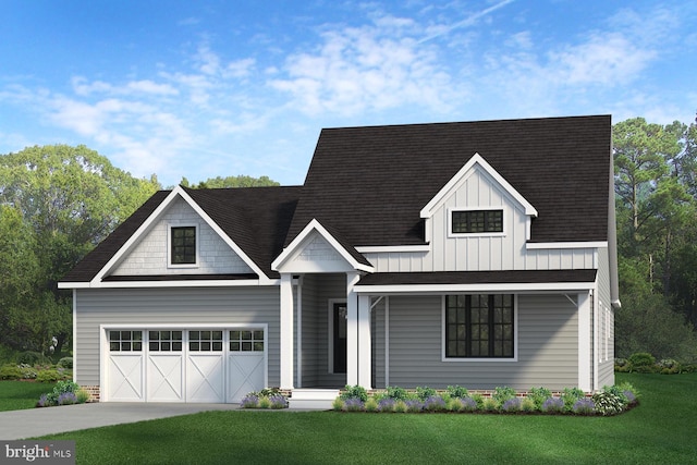 view of front of home with a front yard and a garage