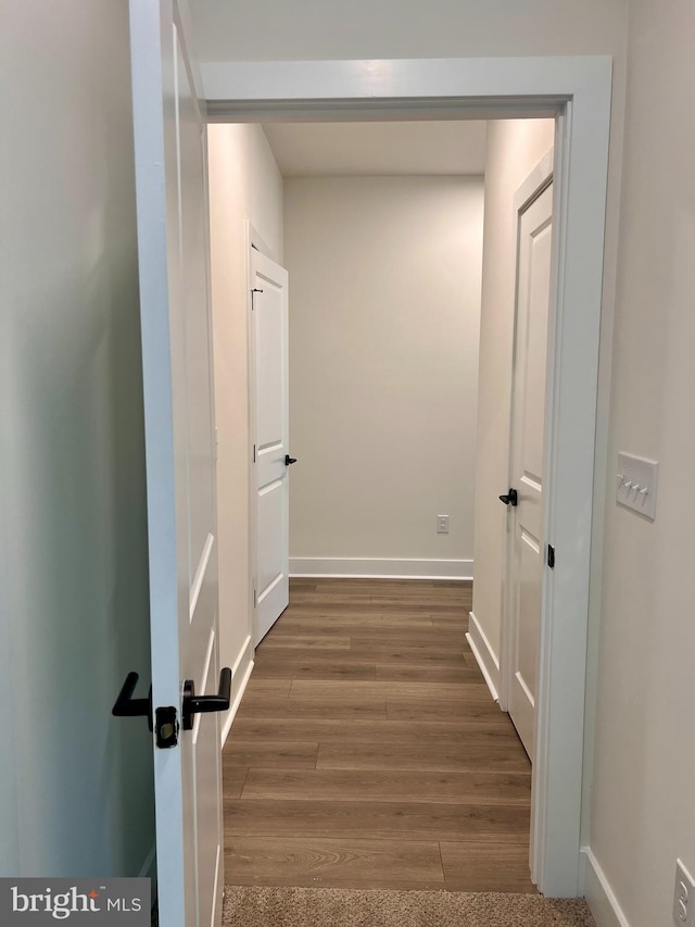 hallway with dark hardwood / wood-style flooring